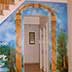 under stairs garden mural with trees, water, bridge close-up